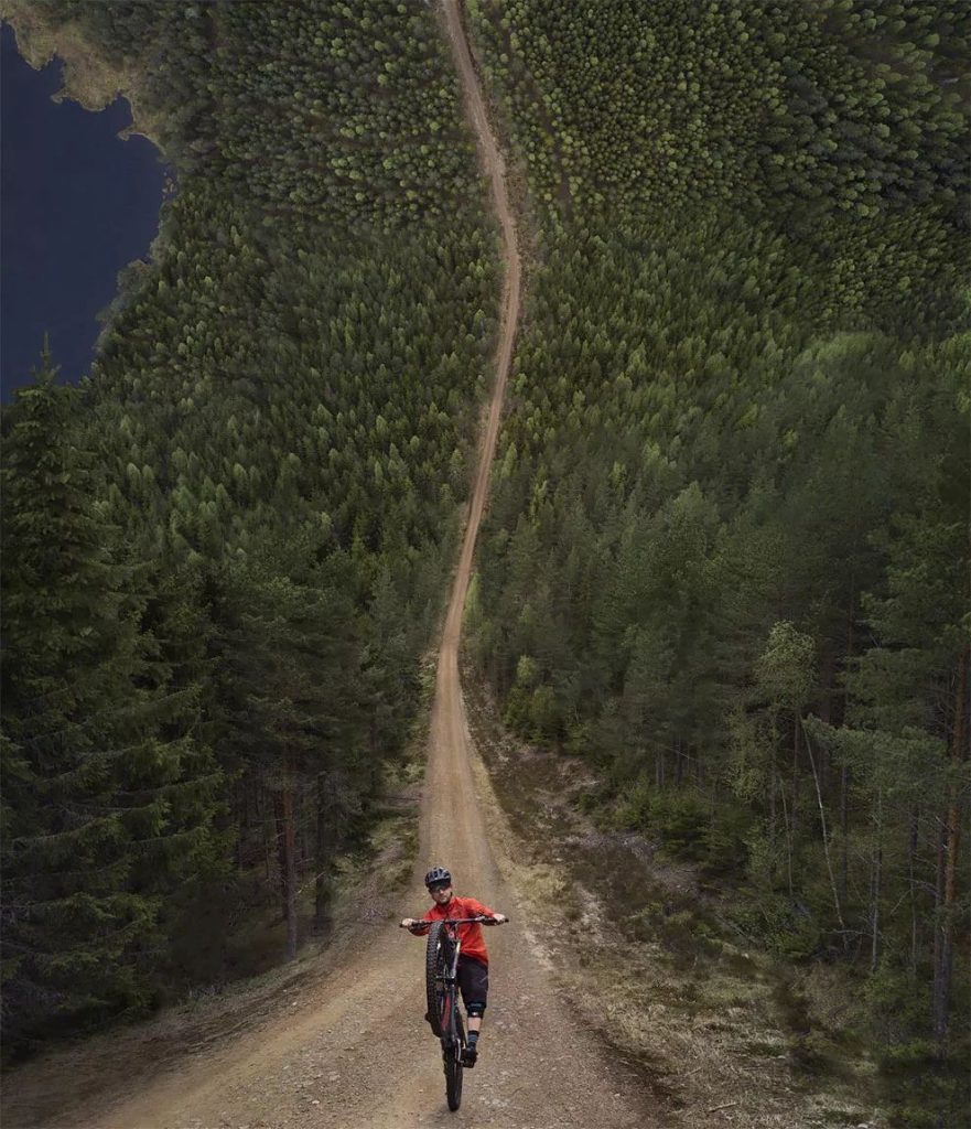 Biker Riding Down A Long Hill